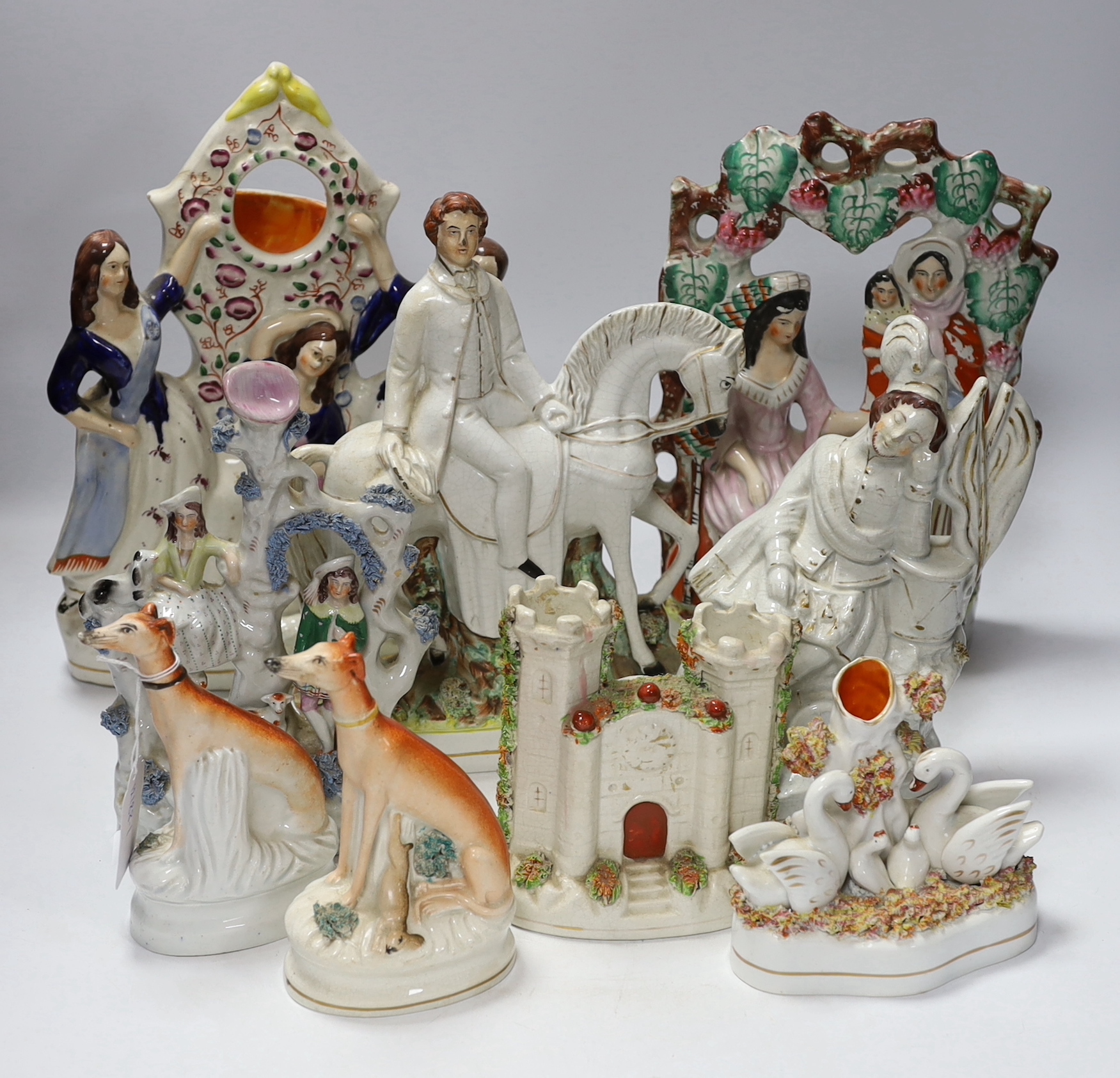 A ‘Fortune Teller’ Staffordshire flatback, eight other figure groups including a pair greyhounds, tallest 30cm high